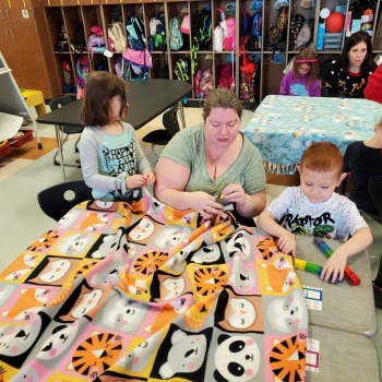 Students making blankets for My Very Own Blanket Organization.